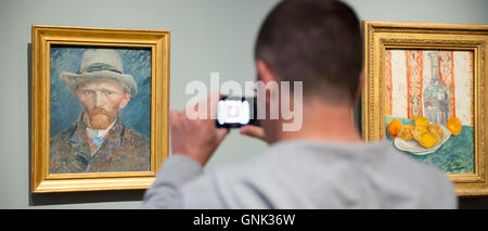 Visitor photographs on smartphone self portrait by Vincent Van Gogh at Rijksmuseum, Amsterdam, Holland Stock Photo