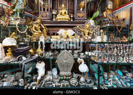 Antiques and jewels of Tibet and Nepal origin on sale in antique shop window in Staalstraat in the Old Town, Amsterdam, Holland Stock Photo