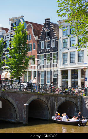 Bridge and canalside gabled houses - Dutch gables - corner Herenstraat and Herengracht, Jordaan District of Amsterdam Stock Photo