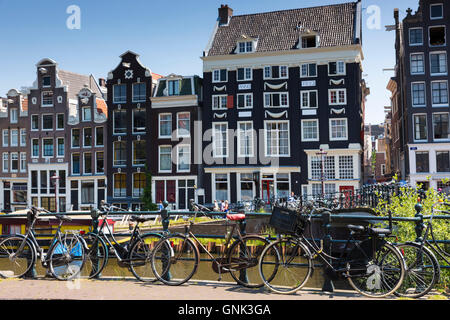 Canalside ornate gabled houses - Dutch gables - and bicycles in canal district in Jordaan, Amsterdam Stock Photo