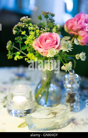 Salt, pepper and vase of flowers at Sonderho Kro Hotel and Restaurant quaint style on Fano Island, Denmark Stock Photo