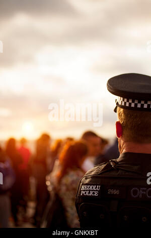 Rhyl Air Show 2016 located on the North Wales coast and held every year. A North Wales Police officer watches over crowds as the sun begins to set Stock Photo