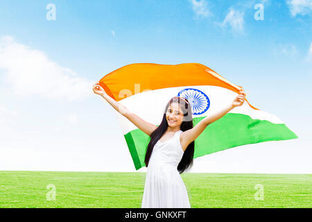 1 indian Teenagers Girl independence Day Park satnding holding flag Fluttering Stock Photo