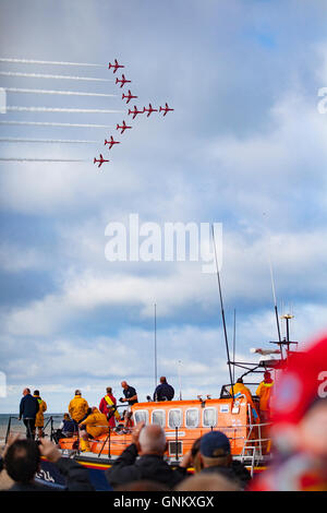 Rhyl Air Show 2016 located on the North Wales coast and held every year. The RAF Red Arrows fly over the RNLI Lift Boat Stock Photo