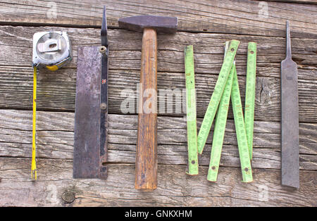 Old used carpentry tools on wooden background Stock Photo