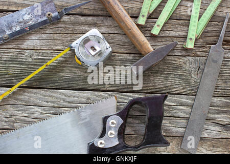 Old used carpentry tools on wooden background Stock Photo