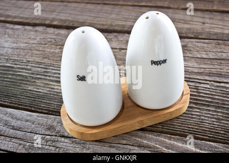 Salt and pepper shakers on wooden background Stock Photo