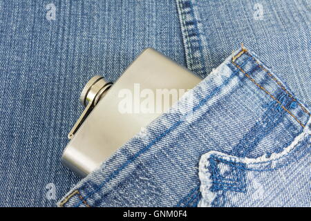 Hip flask in denim blue jeans pocket Stock Photo