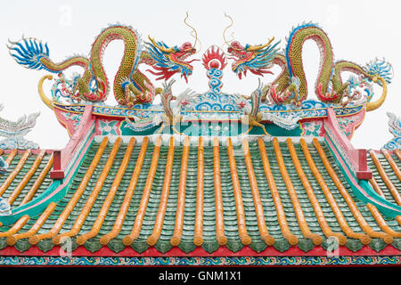 Chinese dragon and pheasant on the roof of the shrine. Isolated. Stock Photo