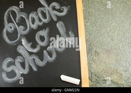 Back to school written on a blackboard Stock Photo