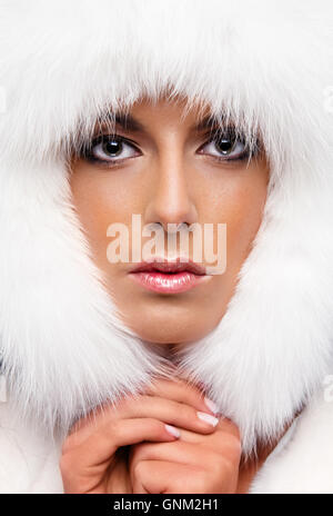 Portrait of a beautiful woman in white fur cap Stock Photo