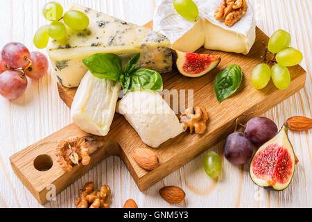 Cheese platter with figs, grapes and nuts Stock Photo