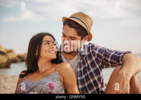 Close up portrait of a happy young cheerful couple having fun camping at the beach Stock Photo