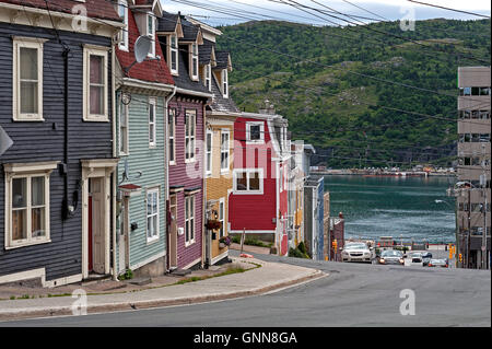 Brightly painted row houses on hillside in city Stock Photo