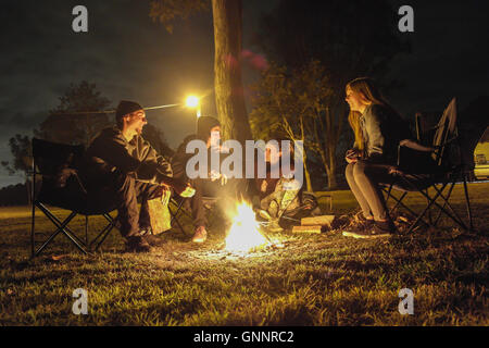 Friends making fire on a Campground near Brisbane - Australia Stock Photo