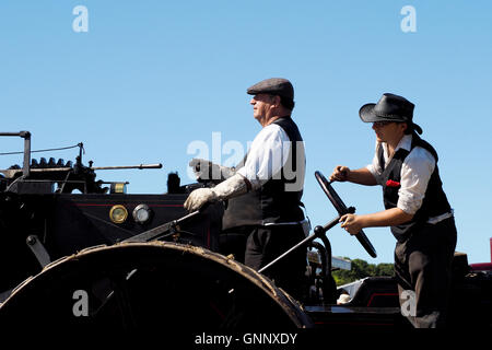 Driver and steersman of a large steam traction engine focus on their job at The Great Dorset Steam Fair 2016 Stock Photo