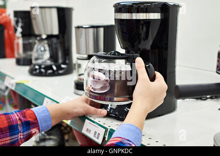 Buyer chooses the coffee machine in the store Stock Photo