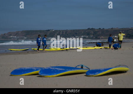 Young people being taught the sport of surfing St.Ouen,Jersey,Channel Islands Stock Photo