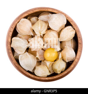 Physalis in a wooden bowl on white background. Edible ripe fruits of Physalis peruviana, a plant in the nightshade family. Stock Photo