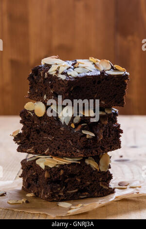 stack of three dark sweet brownies with sliced almonds Stock Photo