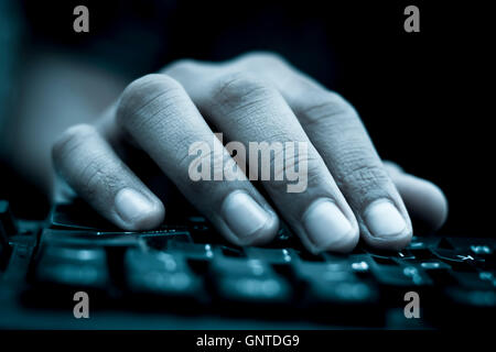 Human hand on keyboard,isolated, selective focus, shallow depth of field, concept of work & technology. Stock Photo