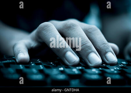 Human hand on keyboard,isolated, selective focus, shallow depth of field, concept of work & technology. Stock Photo