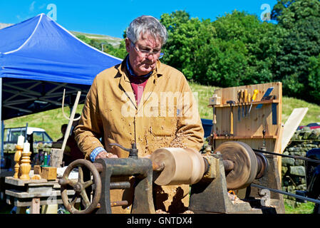 Man working piece of wood on lathe at Reeth Show, Swaledale, North Yorkshire, England UK Stock Photo