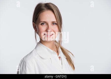 Medical doctor woman standing isolated on white background. Looking at camera Stock Photo