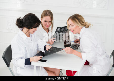 Group Of Doctors Having Meeting In A Hospital office examining x-ray Stock Photo