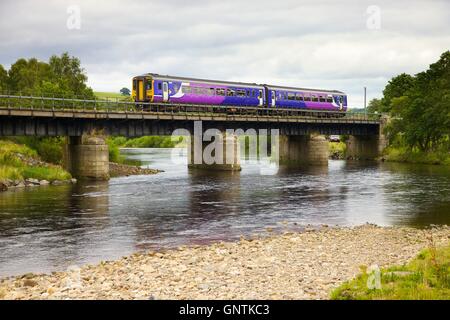 Class,156 Super Sprinter train. South Tyne river, Ridley Hall Railway Bridge, Bardon Mill, Newcastle & Carlisle Railway, UK. Stock Photo