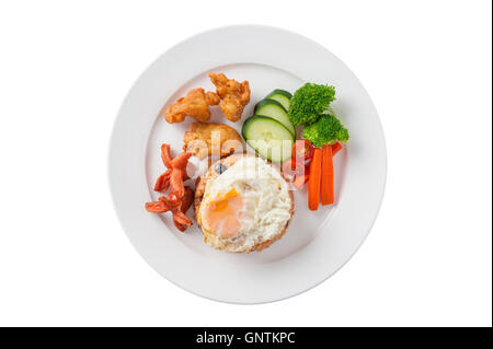 Top view of Thai style cuisine fried rice with raisin deep fried chicken, sausage, and fried egg garnished with vegetables in ce Stock Photo