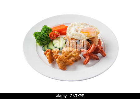 Front view of Thai style cuisine fried rice with raisin deep fried chicken, sausage, and fried egg garnished with vegetables in  Stock Photo
