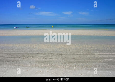 3 jet skis on the ocean near the beach Stock Photo