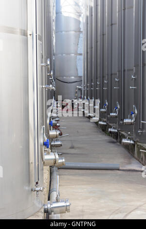 Photo of metal wine barrels at factory Stock Photo