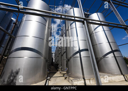 Photo of metal wine barrels at factory Stock Photo