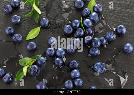blueberries with ice on a slate table. Stock Photo