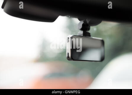 Car video recorder installed on front window, close up photo Stock Photo