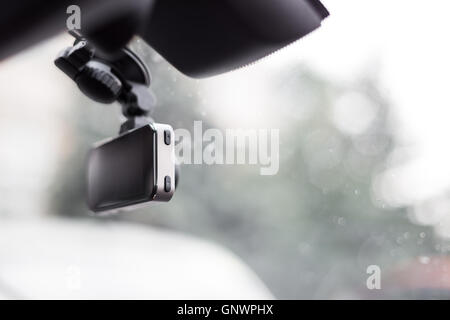 Car video recorder installed on front window, close up photo Stock Photo