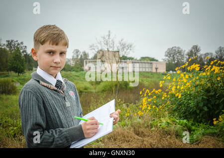 Portrait of a schoolboy apprentice on the background of the school Stock Photo