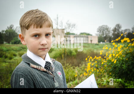 Portrait of a schoolboy apprentice on the background of the school Stock Photo