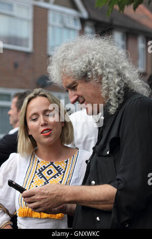 Feltham, London, England, UK. 1st September 2016.  Brian May from rock group Queen putting his own photos on twitter after unveiling an English Heritage Blue Plaque for the former lead singer Freddie Mercury. On what would have been Freddie's 70th birthday the Blue Plaque showing his birth name Fred Bulsara was unveiled on his former home at Feltham in West London, where he lived with his family in the 1970's. Credit:  Julia Gavin UK/Alamy Live News Stock Photo