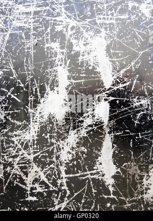 Scratched grungy black and silver surface background texture Stock Photo