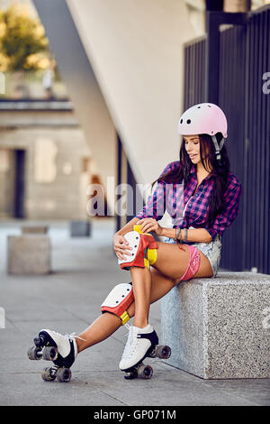 Active lifestyle girl is going to ride on roller skates Stock Photo