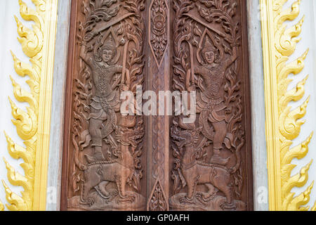 Ornament on wooden door at a public temple show details of carvings and wood texture, close up. Stock Photo