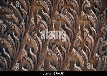 Ornament on wooden door at a public temple show details of carvings and wood texture, close up. Stock Photo