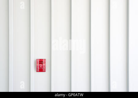 Fire alarm pull switch on white wall, copy space. Stock Photo