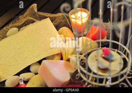 still life blank paper note to fill text under candle light with flower over decorated background for love theme and valentine c Stock Photo