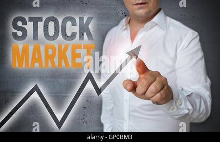 stock market touchscreen is operated by man. Stock Photo