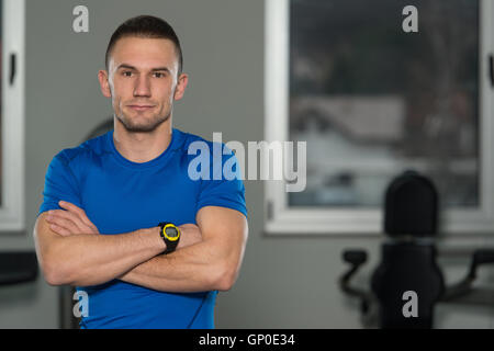 Personal Trainer In Sports Outfit Takes Notes On Clipboard In A Fitness  Center Gym Standing Strong Stock Photo - Alamy