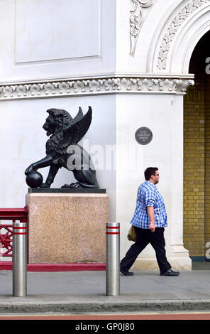 London England, UK. Holborn Viaduct -  man walking past lion statue Stock Photo